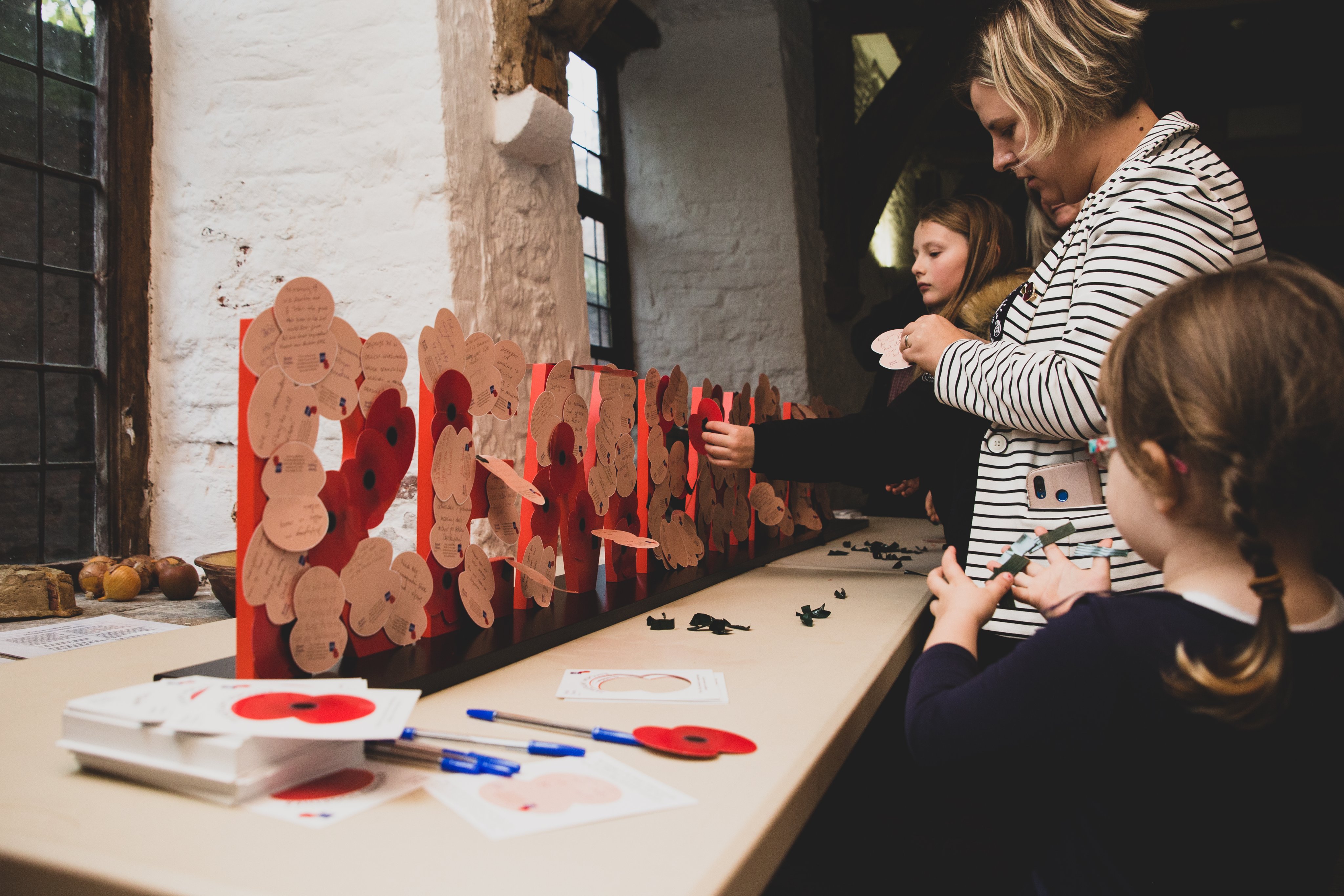 Photo of families writing Remembrance messages during a public event